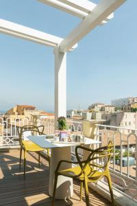 a patio with a table and chairs on a balcony at Altavilla in Gaeta