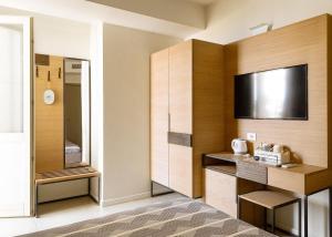 a hotel room with a bed and a flat screen tv at Altavilla in Gaeta