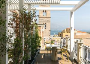 a balcony with a table and chairs and a view at Altavilla in Gaeta