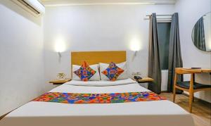 a bedroom with a bed and a desk in a room at Via Urban Residency in New Delhi