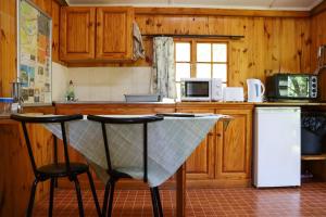 a kitchen with a table and two chairs in it at Mount Park Guest Farm in Dargle