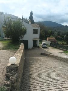 una casa con un muro di pietra e un vialetto di Thalia suite Corfu Town a Gastouri