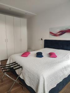 a bedroom with a large bed with pink and blue pillows at Ca' Monica Apartment in Venice