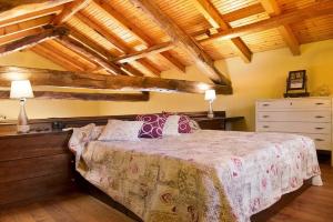 a bedroom with a bed in a room with wooden ceilings at Agriturismo - Tenuta MonteOliveto - Cottage Romantic in Vesime