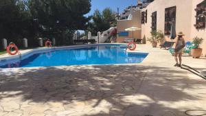 a man standing next to a swimming pool at MARINA BEACH FRONT in La Herradura