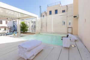 a swimming pool with towels on top of a building at Amazing 3 Levels Penthouse Piazza Venezia in Rome