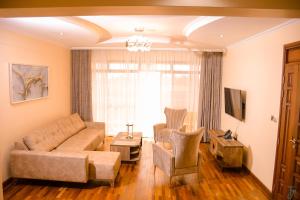 a living room with a couch and a chair at TJ's Boutique Hotel in Eldoret