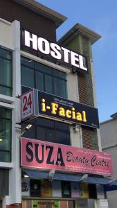 a hotel with a sign on the side of a building at Suza Hostel in Tumpat