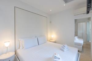 a white bedroom with a large white bed and a sink at Amazing 3 Levels Penthouse Piazza Venezia in Rome