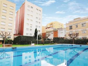 una piscina al centro di due edifici di Apartamento con vistas al mar y piscina a Pineda de Mar
