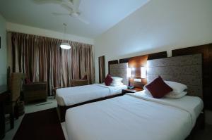 Letto o letti in una camera di Hotel Devaragam by K P Namboodiri's