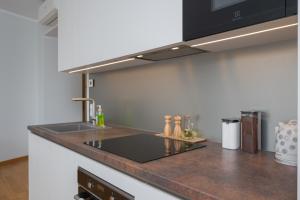 a kitchen with a sink and a counter top at Fortune Apartments - City, Contactless in Tartu