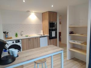 a kitchen with a counter top and a stove top oven at Gîte et SPA Au Secret Du Bonheur in Pouilly-sur-Serre
