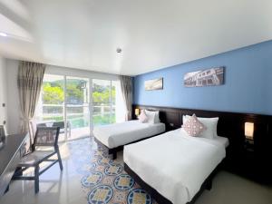 Postel nebo postele na pokoji v ubytování Grand Supicha City Hotel - SHA Plus