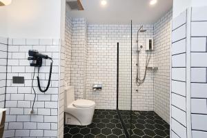 a bathroom with a shower and a toilet at Taladnoi Paint House in Bangkok