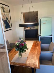 a dining room table with a vase of flowers on it at Ferienwohnung Nahe Gmunden Top 3 in Pinsdorf