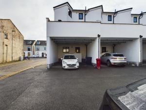 a car garage with two cars parked in it at Cosy and luxurious house for 10 guests in Darwen in Darwen