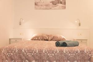 a bedroom with a bed with two towels on it at Modern Apartment in Central Romantic Quarter in San Sebastián