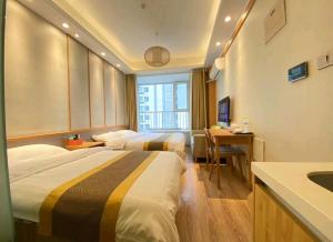 a hotel room with two beds and a sink at Qingdao Shuiyunjian Apartment in Qingdao