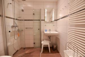 a bathroom with a shower and a sink at Haus "Jan am Strand" Appartement JAN017 in Döse
