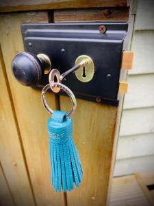 a blue tassel hanging from a door handle at The Drivers Rest a Shepherds in beautiful surroundings in Oakmere Cheshire in Delamere