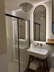 a bathroom with a sink and a shower at URBAN Penthouse FREE parking i rowery in Poznań