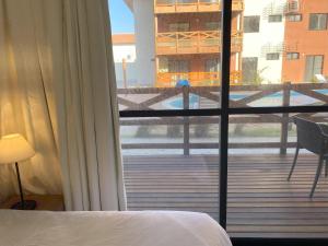 a bedroom with a view of a balcony at Vila Atlântida Beach in Luis Correia