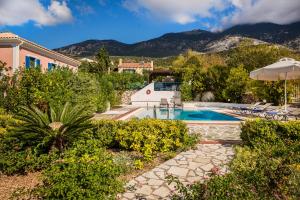 a villa with a swimming pool and mountains in the background at Villa Rudi in Trapezaki