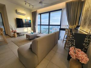 a living room with a couch and a large window at Executive Urban Suites - George Town @ Penang in Jelutong