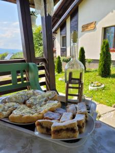 a table with a plate of bread and a bottle of wine at Casa Dunca in Sighetu Marmaţiei +81 photos