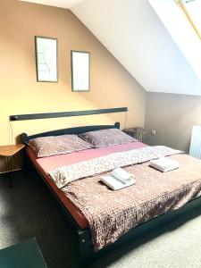 a bedroom with a bed with two books on it at Penzion a restaurace U Nováků in Bítovany