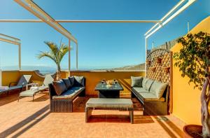 a patio with two couches and a table at Nayara Sunset in Adeje