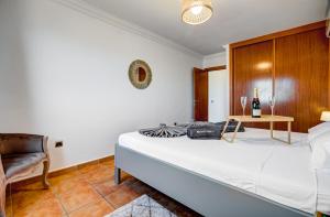 a bedroom with a bed with a table and a chair at Nayara Sunset in Adeje