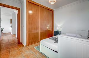 a bedroom with a bed and a wooden cabinet at Nayara Sunset in Adeje