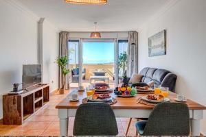 a living room with a table with food on it at Nayara Sunset in Adeje +15 photos