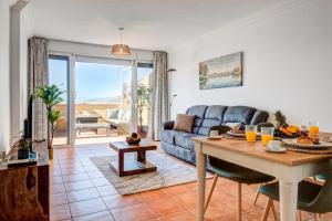 a living room with a couch and a table at Nayara Sunset in Adeje