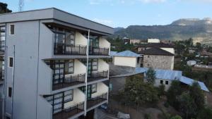 an apartment building with balconies on the side of it at Amba Lodge Lalibela in Lalibela