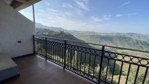 a balcony with a view of the mountains at Amba Lodge Lalibela in Lalībela