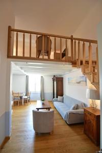 a living room with a couch and a loft at Douskos Guesthouse in Hydra