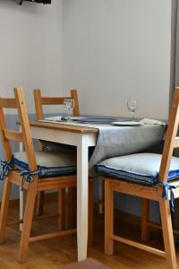 a table with two chairs and a table with two glasses on it at Douskos Guesthouse in Hydra