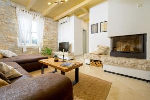 a living room with a couch and a fireplace at Villa Onelia by IstriaLux in Vodnjan