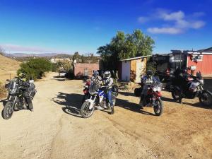 a group of people riding motorcycles on a dirt road at Ecovino Valle de Guadalupe in Valle de Guadalupe
