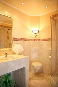 a bathroom with a sink and a toilet at Landhotel Zur Post in Bad König +41 photos
