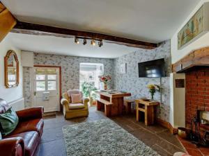 sala de estar con sofá y mesa en Beautiful 2 Bedroom Riverside Cottage en Bridgnorth