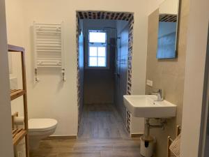 a bathroom with a sink and a toilet at Apartment on the ground floor in Gutenzell-Hürbel