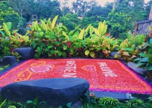 a carpet of flowers at a garden at PONDOK KUNGKANG VILLA 2 in Ubud