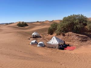 two tents in the middle of a desert at Dar Nomads in Mhamid