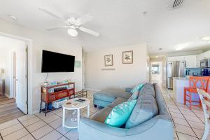 a living room with a couch and a flat screen tv at Sunset Harbor Villas #4-421 in Navarre