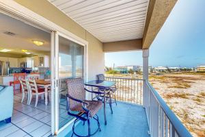 a balcony with a table and chairs and a table at Sunset Harbor Villas #4-421 in Navarre