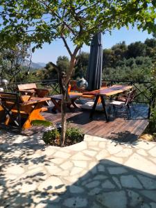 a patio with a table and an umbrella at Villa Mutaf in Kumluca